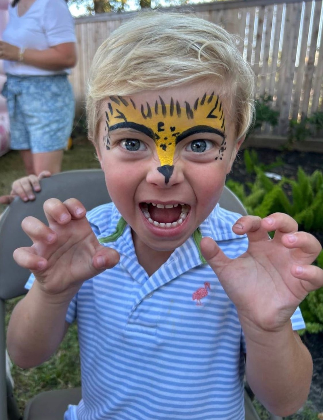 Cheetah face painting on a child at a Texas party