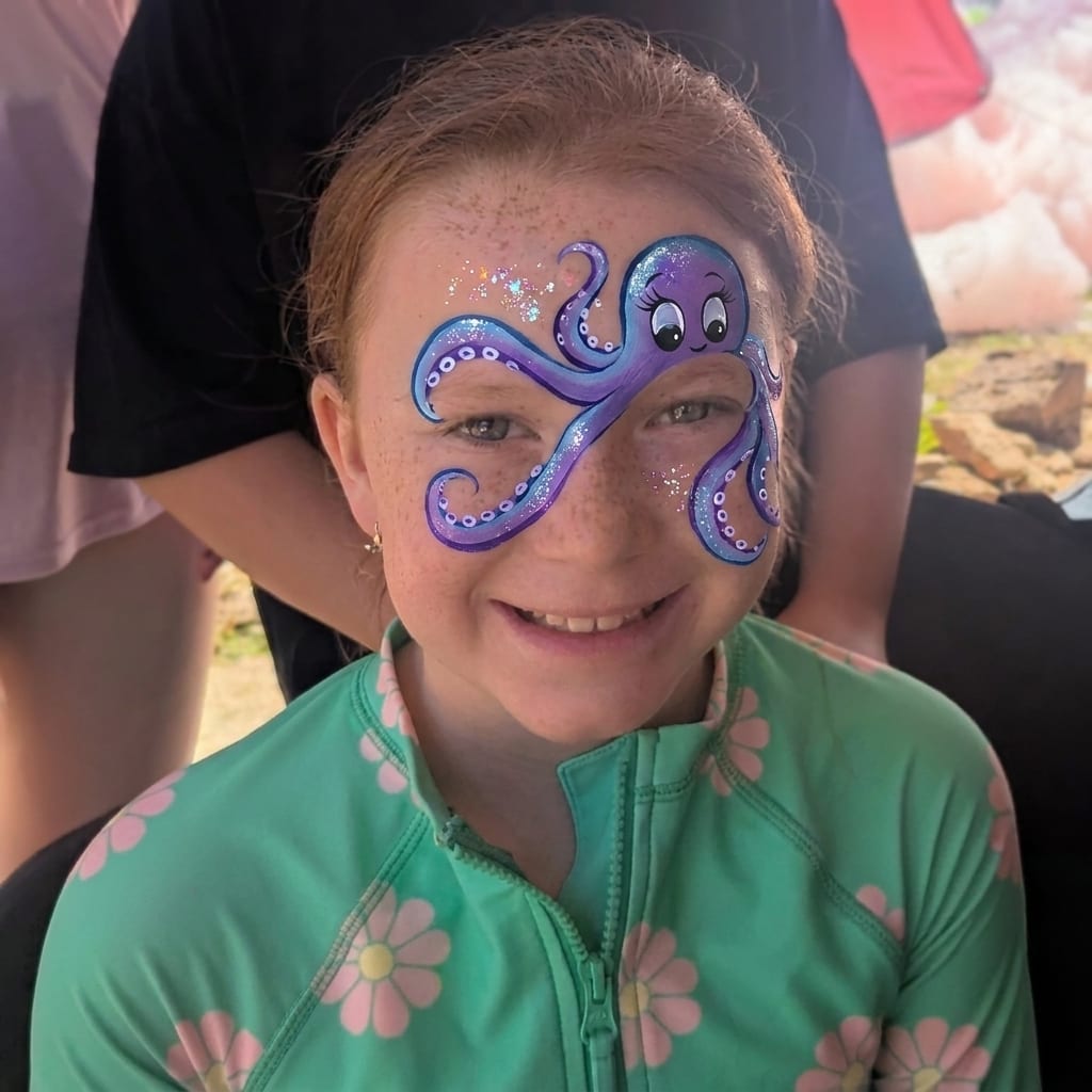 Colorful ocean themed face painting on a girl at a Texas party